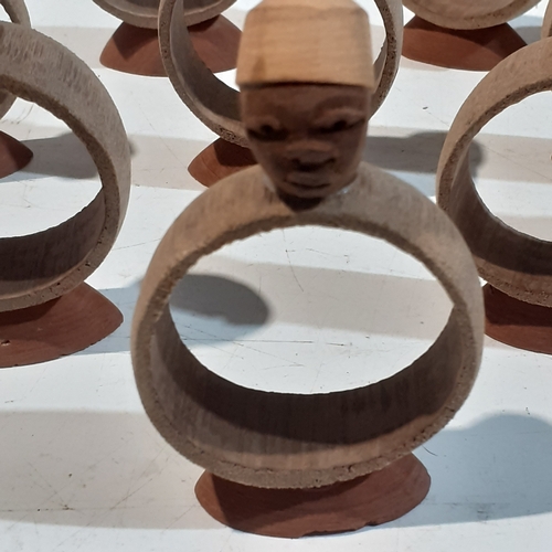 44 - Collection of wooden napkin rings with different designs of African style heads. Unusual pieces.  Ni... 