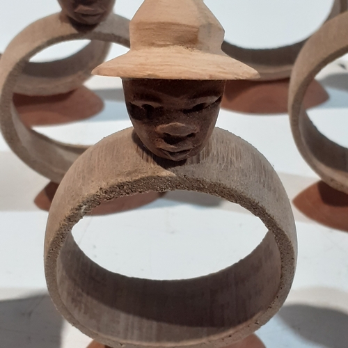 44 - Collection of wooden napkin rings with different designs of African style heads. Unusual pieces.  Ni... 