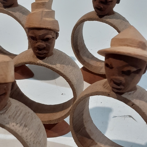 44 - Collection of wooden napkin rings with different designs of African style heads. Unusual pieces.  Ni... 