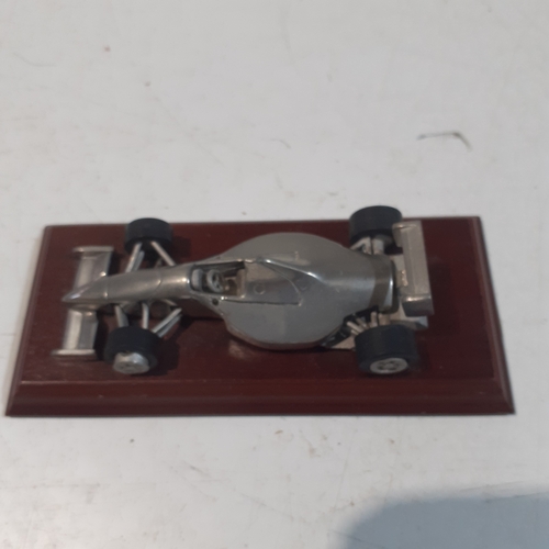 48 - Royal Hampshire Formula One, pewter racing car on wooden plinth.