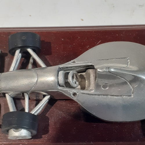 48 - Royal Hampshire Formula One, pewter racing car on wooden plinth.