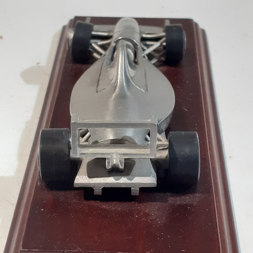 48 - Royal Hampshire Formula One, pewter racing car on wooden plinth.