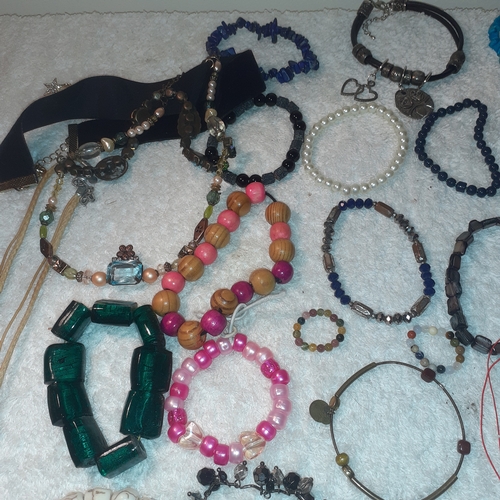 60 - A large quantity of beaded and stone bangles and a couple of necklaces. All complete with working cl... 