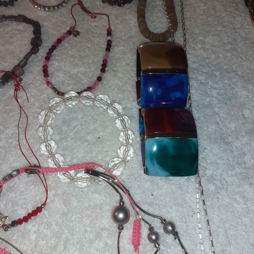 60 - A large quantity of beaded and stone bangles and a couple of necklaces. All complete with working cl... 