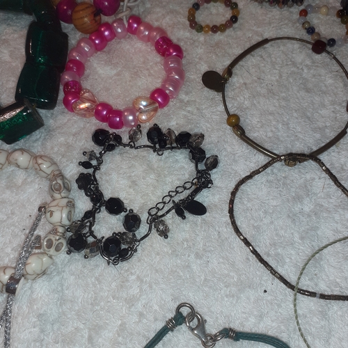 60 - A large quantity of beaded and stone bangles and a couple of necklaces. All complete with working cl... 