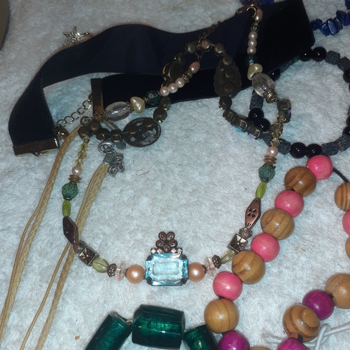 60 - A large quantity of beaded and stone bangles and a couple of necklaces. All complete with working cl... 