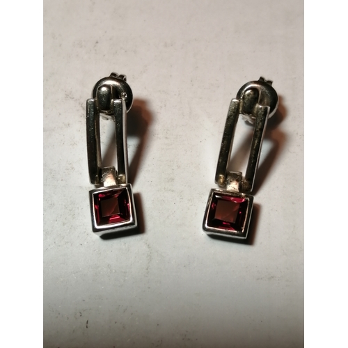 24A - Silver earrings each set with single square cut red gemstone 4.43 grams