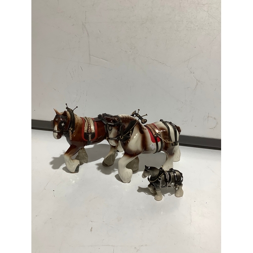 40 - Two larger & one smaller ceramic shire horses