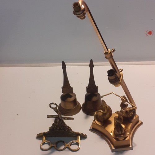 5 - A selection of brass pieces, a pipe holder, pair of bells and an unusual lamp.