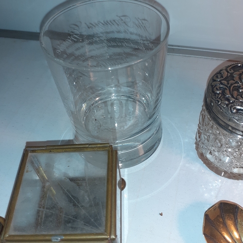 7 - An interesting selection of mainly metal pieces. Includes a ships wheel clock, some silver plate,  a... 