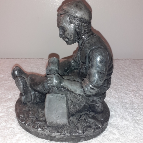 11 - Pewter ornament of old man sitting working.