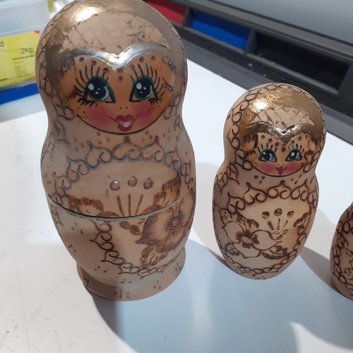 9 - Russian Dolls x 5 burnt in decoration on natural wood . Very collectable.