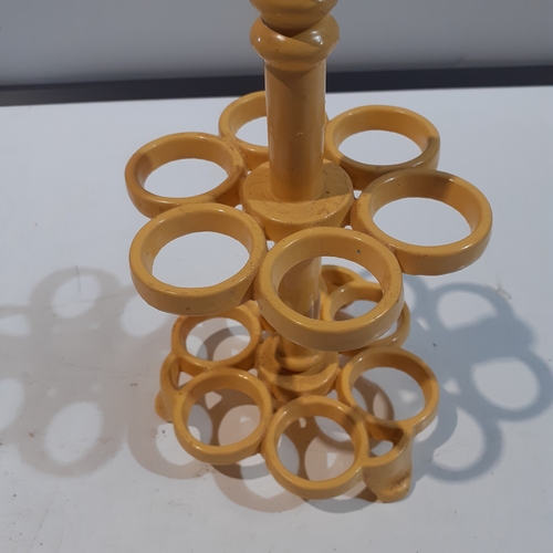 1 - Cast iron egg holder. Yellow, heavy and good condition.