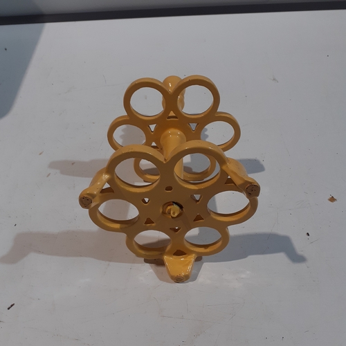 1 - Cast iron egg holder. Yellow, heavy and good condition.