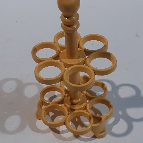 1 - Cast iron egg holder. Yellow, heavy and good condition.