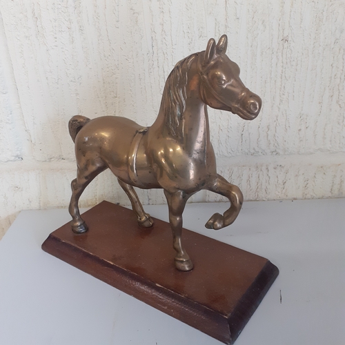 54 - Brass horse on a wooden plinth. Weight is