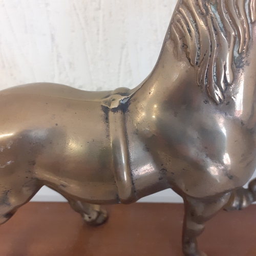 54 - Brass horse on a wooden plinth. Weight is