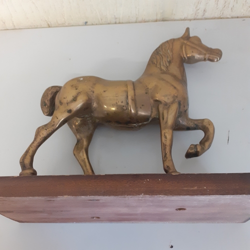 54 - Brass horse on a wooden plinth. Weight is