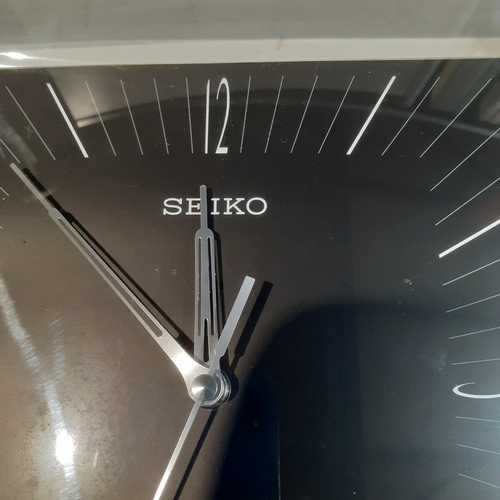 12 - Seiko Square chrome finish square wall clock in good condition and working . QXA330KN