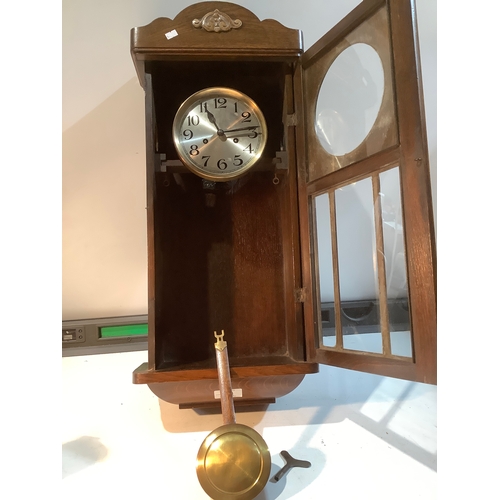 133 - Oak cased wall clock with pendulum approx 89cm x 32cm