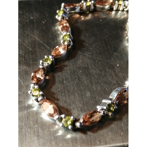 29A - Silver bracelet encrusted with green and amber gemstones 11.31 grams