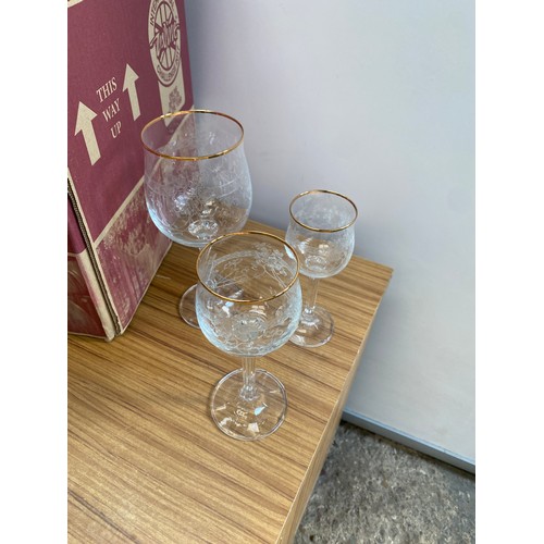 507 - Large selection of wine, champagne flutes and port glasses with etched pattern and gold coloured rim