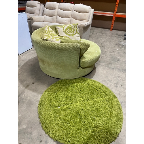 292 - Large green swivel cuddle chair with green circular under rug