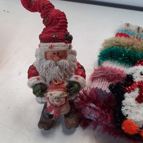 4 - A quantity of Christmas decorations, including stockings, Santa ornaments, teddy bears and more