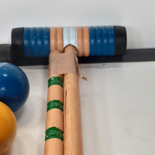 18 - Croquet set. Set of sticks, balls, pegs etc. Played with but good condition