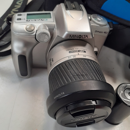 22 - Minolta Dynax 40 SLR camera with AF 38-100 lens. Includes a 35mm film new in box, case qnd instructi... 