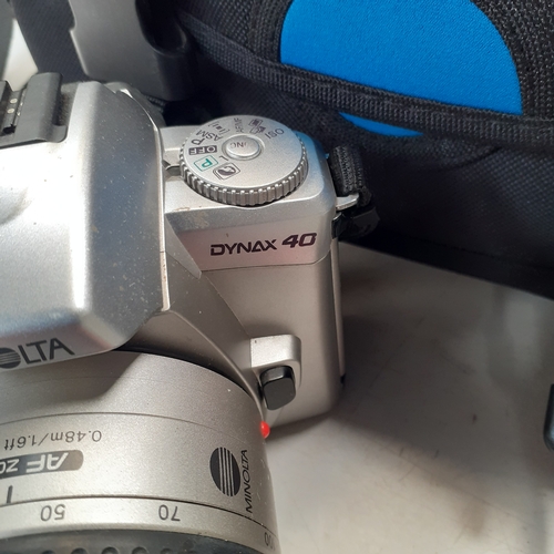 22 - Minolta Dynax 40 SLR camera with AF 38-100 lens. Includes a 35mm film new in box, case qnd instructi... 