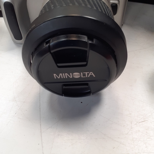 22 - Minolta Dynax 40 SLR camera with AF 38-100 lens. Includes a 35mm film new in box, case qnd instructi... 