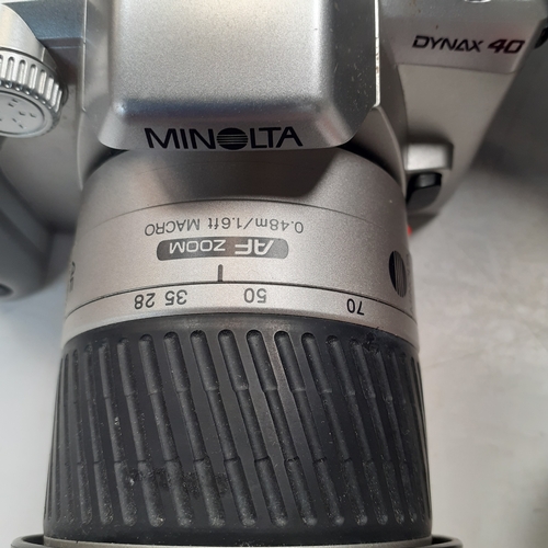 22 - Minolta Dynax 40 SLR camera with AF 38-100 lens. Includes a 35mm film new in box, case qnd instructi... 