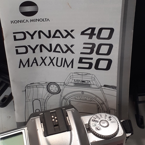 22 - Minolta Dynax 40 SLR camera with AF 38-100 lens. Includes a 35mm film new in box, case qnd instructi... 