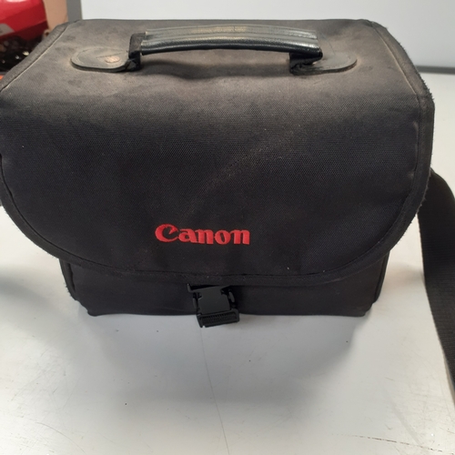 23 - Canon EOS 300 SLR camera with 35-80mm zoom lens and case. Some minor scratches on surface of camera ... 