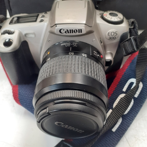 23 - Canon EOS 300 SLR camera with 35-80mm zoom lens and case. Some minor scratches on surface of camera ... 