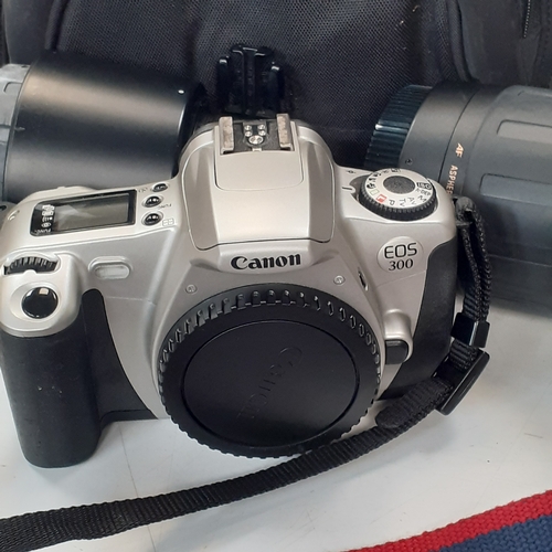 24 - Canon EOS 300 SLR camera with 2 x Tamron lenses and a  Lowepro case. Used, good condition