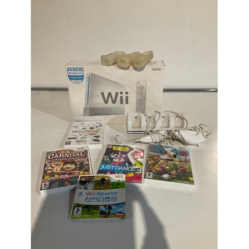167 - Boxed Wii console with 3 controllers, nunchucks and controller skins barely been used and games to i... 