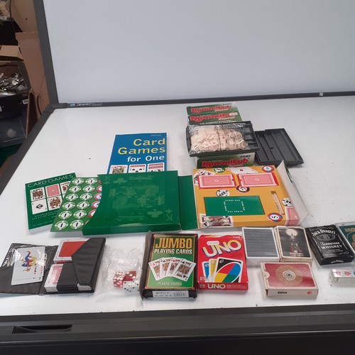 10 - A quantity of playing cards and related items. Includes Uno, giant cards, a compendium if card games... 