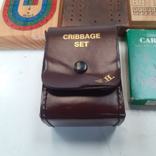 9 - 5 very  attractive cribbage boards with a sixth small cased one and 3 decks of playing cards. Some g... 