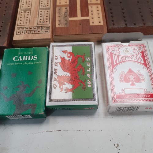 9 - 5 very  attractive cribbage boards with a sixth small cased one and 3 decks of playing cards. Some g... 