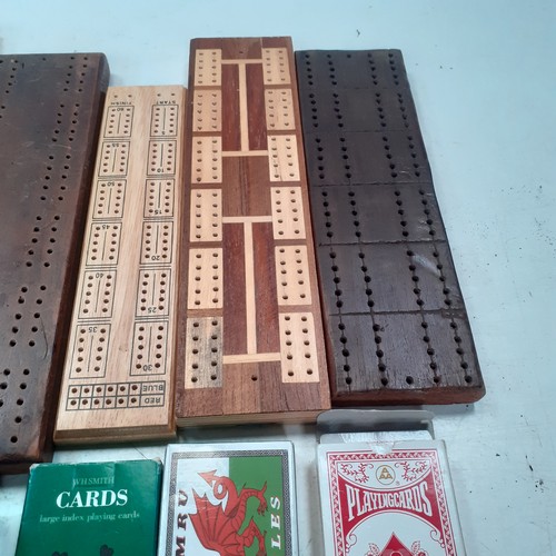 9 - 5 very  attractive cribbage boards with a sixth small cased one and 3 decks of playing cards. Some g... 