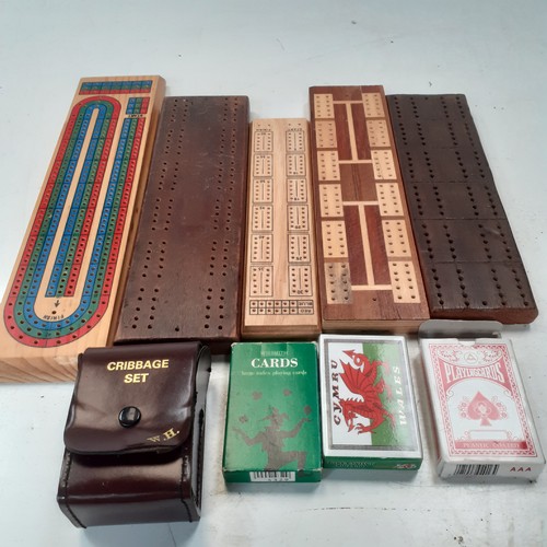 9 - 5 very  attractive cribbage boards with a sixth small cased one and 3 decks of playing cards. Some g... 