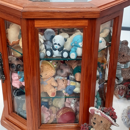 17 - Large quantity of small ceramic amd pottery bear ornaments.  Loads inside two smal glazed display ca... 