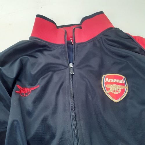 24 - 2 Arsenal tops. One hoodie and one tracksuit top. Havr been worn condition and would benefit from a ... 