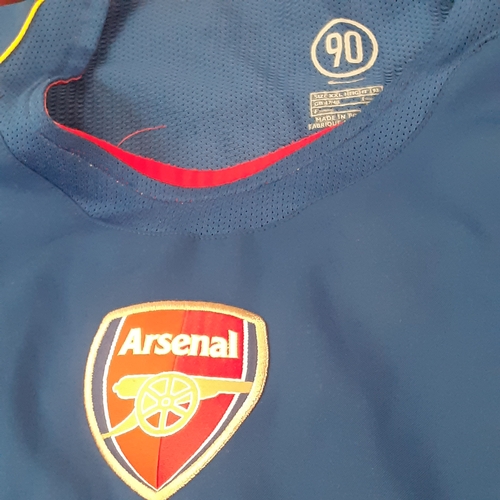 25 - A quantity of Arsenal shirts.  There is wear on the purple ones transfer 