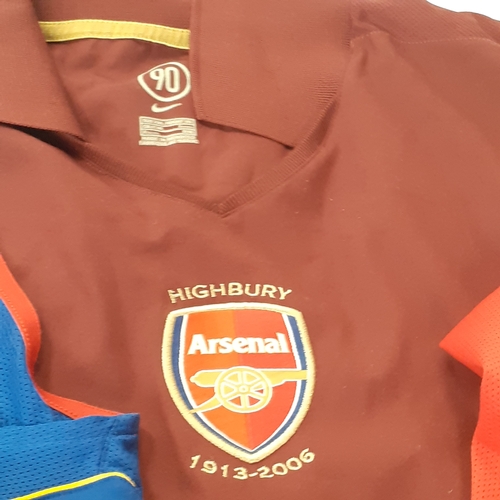 25 - A quantity of Arsenal shirts.  There is wear on the purple ones transfer 