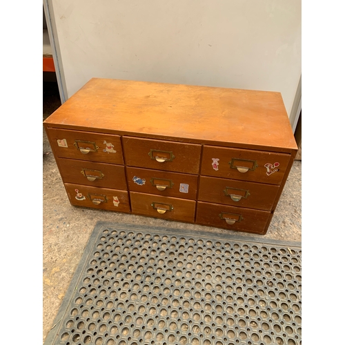 334 - 90cm long bank of 9 drawers