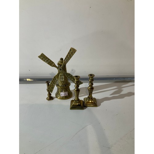 114 - 3 small brass candle sticks and a brass windmill