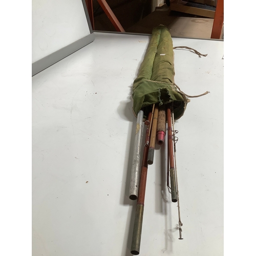 305 - Vintage fishing rods in bag